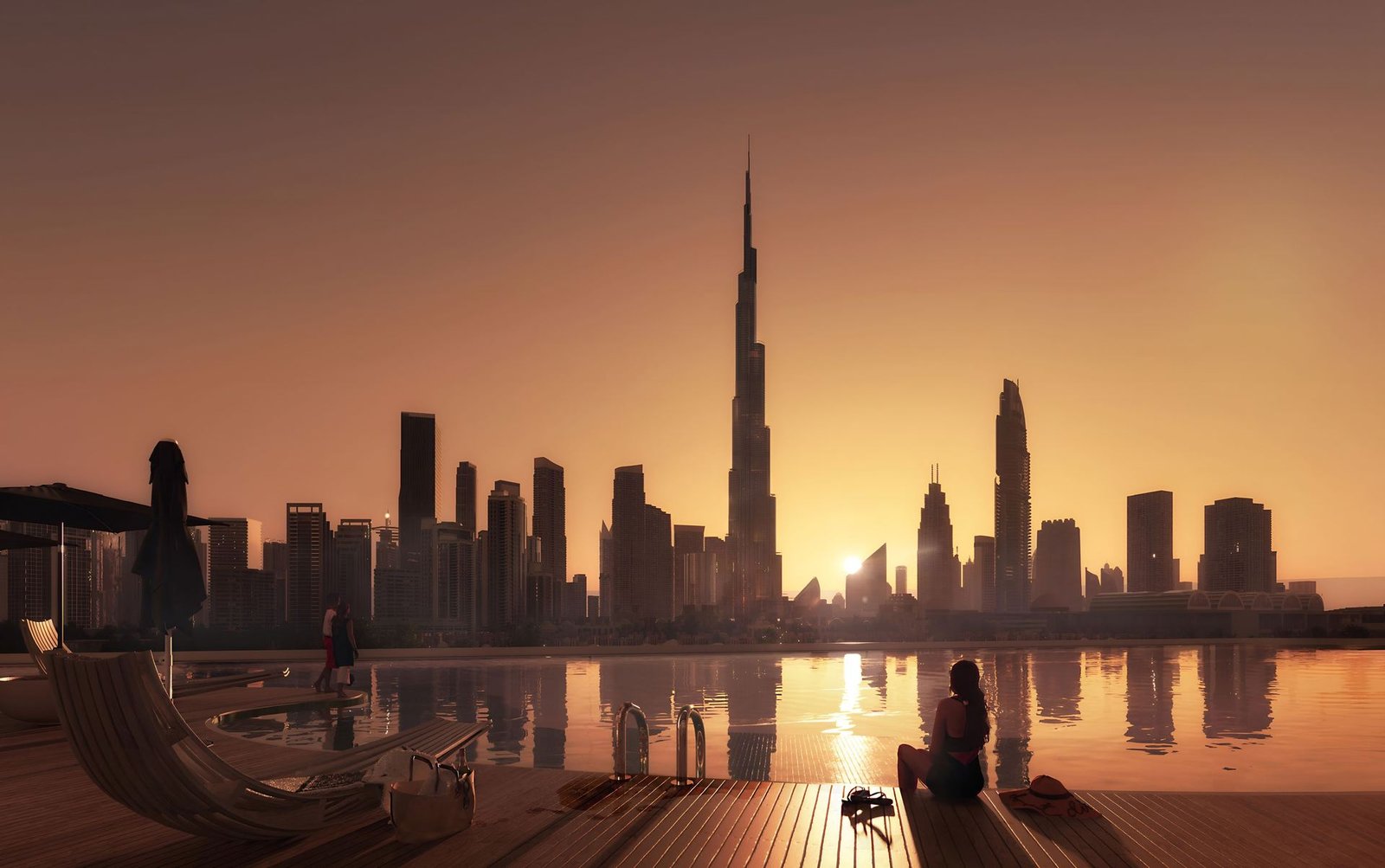 Sunset over the pool deck with the Burj Khalifa skyline in silhouette